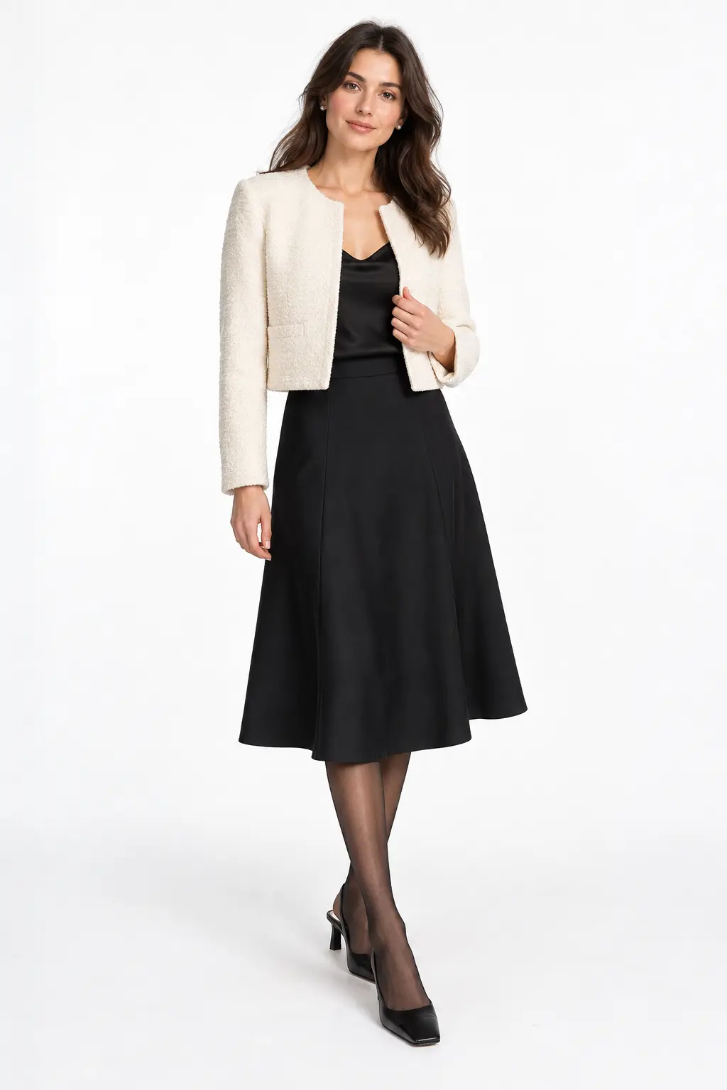 Ivory Boucle Jacket and Black Midi Skirt Full-body white-studio image of a woman wearing ivory collarless boucle jacket; black camisole; black A-line midi skirt; sheer tights; black slingback heels.