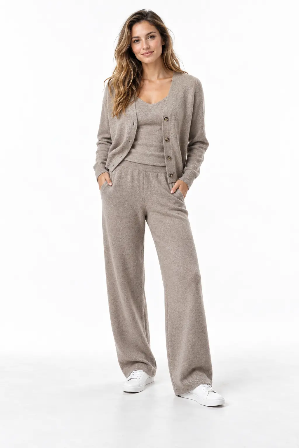 Taupe Knit Travel Set Full-body white-studio image of a woman wearing taupe cardigan; matching shell and wide knit trousers; white sneakers.